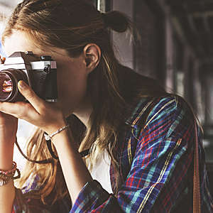 Close-up of girl taking a picture.