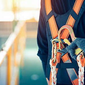 Close-up of construction worker’s safety harness and safety line.