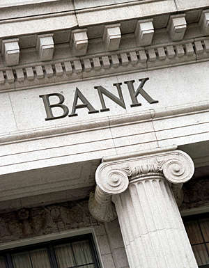 Frontispiece of a grand-looking building displaying the word “bank”.