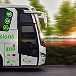 Close side view of a zero-emissions bus in motion against a blurred green background.